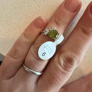 Size 6 green and white stone, white metal ring.
